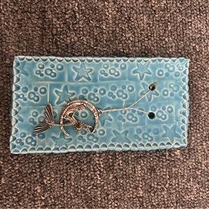Silver Dolphin Pendant on Blue Ceramic Tray